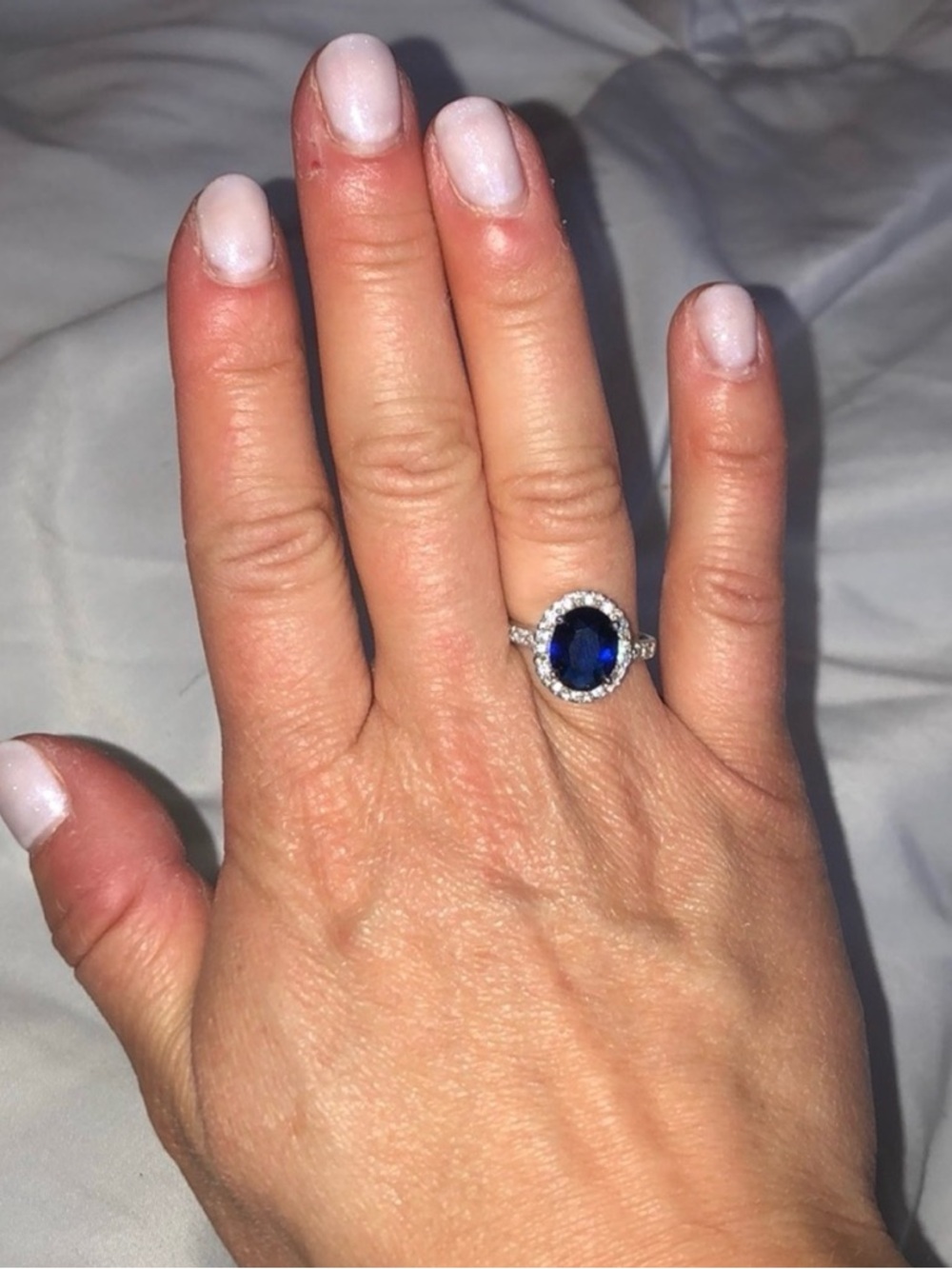 Sterling Silver Halo Ring with Deep Blue Oval Stone
